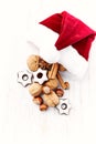 Santa Claus hat with nuts, spices and chocolates. Christmas background Royalty Free Stock Photo