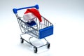 Santa Claus hat on a shopping trolley. Christmas and New Year discount concept, online, consumer basket level, black friday and