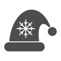 Santa claus hat solid icon. Christmas hat with snoflake vector illustration isolated on white. Christmas cap glyph style