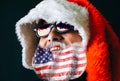 Santa Claus in hat and sunglasses is laughing. American flag on the beard. LGBT friendly. Celebration concept. 2020 new year