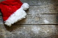 Santa Claus hat on vintage wooden boards christmas background Royalty Free Stock Photo