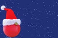 Santa Claus hat is worn on a New Year's, round toy on an evening background with snowflakes. 3D rendering