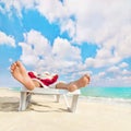 Santa Claus have e rest in chaise longue on sea beach Royalty Free Stock Photo