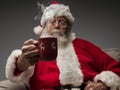 Santa Claus having an hot drink