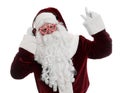 Santa Claus with headphones listening to Christmas music on white background Royalty Free Stock Photo