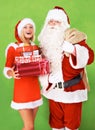 Santa claus, helper or Christmas gift box on studio green background for festive season, holiday or present giving Royalty Free Stock Photo