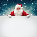 Santa Claus holding blank advertisement banner