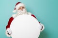 Santa Claus holding blank cardboard circle