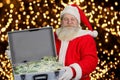 Santa Claus holding case with money. Royalty Free Stock Photo