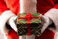 Santa claus holding christmas present with copy space on black background Royalty Free Stock Photo