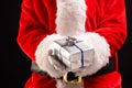 Santa claus holding christmas present with copy space on black background Royalty Free Stock Photo