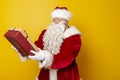 Santa Claus holding Christmas present Royalty Free Stock Photo