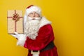Santa Claus holding Christmas present Royalty Free Stock Photo