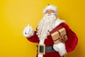 Santa Claus holding Christmas present Royalty Free Stock Photo