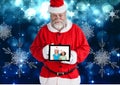 Santa claus holding a digital tablet with photo of christmas kids Royalty Free Stock Photo