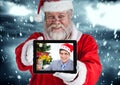 Santa claus holding a digital tablet with photo of man Royalty Free Stock Photo