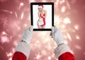 Santa claus holding a digital tablet with photo of santa girl Royalty Free Stock Photo