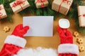 Santa Claus holding letter on wooden table with gift boxes and Christmas tree and cup of hot coffee or tea. mockup blank Royalty Free Stock Photo