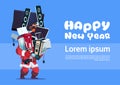 Santa Claus Holding Pile Of Modern Electronics Gadgets On Happy New Year Banner