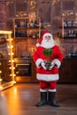 Santa claus holding a potted houseplant for christmas. Royalty Free Stock Photo