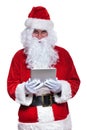 Santa claus holding and reading on a tablet pad Royalty Free Stock Photo