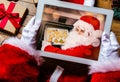 Santa Claus holding tablet device Royalty Free Stock Photo