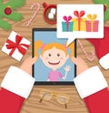 Santa claus is holding tablet and having conversation with young girl who talks about gifts he would like to get at christmas