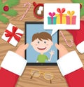 Santa claus is holding tablet and having conversation with young kid who talks about gifts he would like to get at christmas