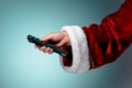 Santa Claus holding tv remote control Royalty Free Stock Photo