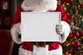 Santa Claus holding white frame in his hands