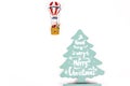 Santa Claus in Hot air balloon flight up to a wood green tree with Merry Christmas written on Royalty Free Stock Photo