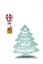 Santa Claus in Hot air balloon flight up to a wood green tree, on white background Royalty Free Stock Photo