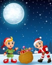 Santa claus kid with cartoon elf present a sack full of gifts in the winter night background Royalty Free Stock Photo