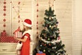 Santa claus kid at Christmas tree. Royalty Free Stock Photo