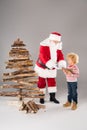 Santa Claus with kid creating Christmas tree Royalty Free Stock Photo