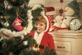 Santa claus kid decorating Christmas tree.. Royalty Free Stock Photo