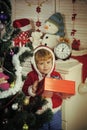 Santa claus kid decorating Christmas tree.. Royalty Free Stock Photo