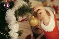 Santa claus kid decorating Christmas tree.. Royalty Free Stock Photo