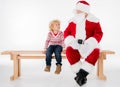 Santa Claus with kid sitting on bench