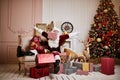 Santa Claus lay down to rest on the sofa with a bunch of gifts near the fireplace and christmas tree . New year and Merry Royalty Free Stock Photo