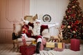 Santa Claus lay down to rest on the sofa with a bunch of gifts near the fireplace and christmas tree . New year and Merry Royalty Free Stock Photo