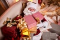 Santa Claus lay down to rest on the sofa with a bunch of gifts near the fireplace and christmas tree . New year and Merry Royalty Free Stock Photo