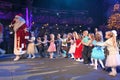 Santa Claus leads the children a cheerful holiday dances. Christmas night. Santa Claus on stage.