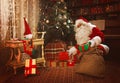 Santa Claus leaving presents under the Christmas tree Royalty Free Stock Photo