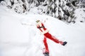 Santa Claus lies on the snow in winter for Christmas Royalty Free Stock Photo