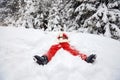 Santa Claus lies on the snow in winter for Christmas Royalty Free Stock Photo