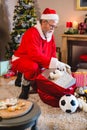 Santa claus listening music on mobile phone at home Royalty Free Stock Photo