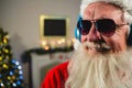 Santa Claus listening to music on headphones Royalty Free Stock Photo