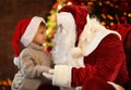 Santa Claus and little boy near Christmas tree Royalty Free Stock Photo