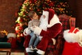 Santa Claus and little boy near Christmas tree Royalty Free Stock Photo